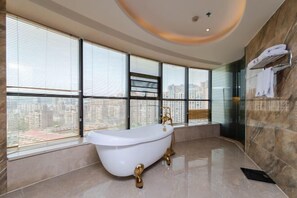 Enjoy a relaxing soak in the bathtub with a view of the city.
