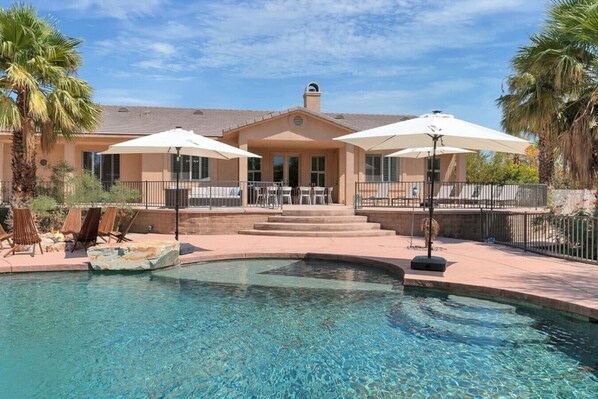 A pool area with a clear blue pool, lounge chairs, and umbrellas. - Natural Springs-2 acre, Games+karaoke, fit,views. (Riverside County)