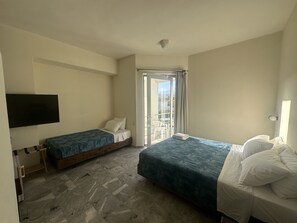 Basic Triple Room | Minibar, in-room safe, desk, soundproofing