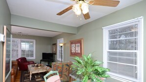 A living room with a ceiling fan, a red leather chair, a coffee table, and a potted plant. - State Line Rd near Downtown Q39 BBQ-KUMC. WESTPORT! (Kansas City)