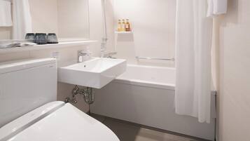 A modern bathroom with a white sink, a bathtub, and a toilet. There are toiletries on a shelf above the sink.