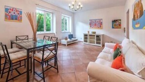 A spacious living area with a dining table and chairs, a white sofa, and a chandelier. - Charming Villa, Ischia, Punta Caruso, Forio, n.3 (Forio)