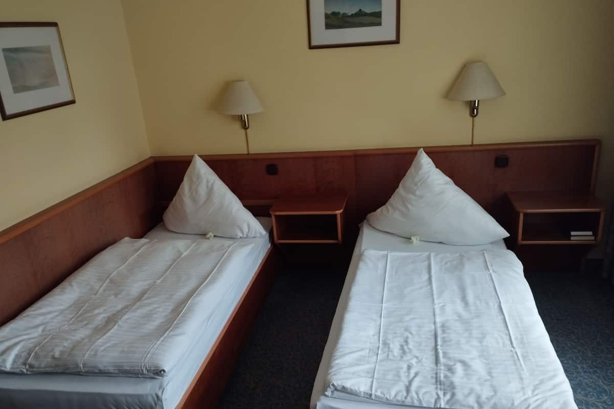 Twin Room | Desk, blackout drapes, iron/ironing board (on request), travel crib