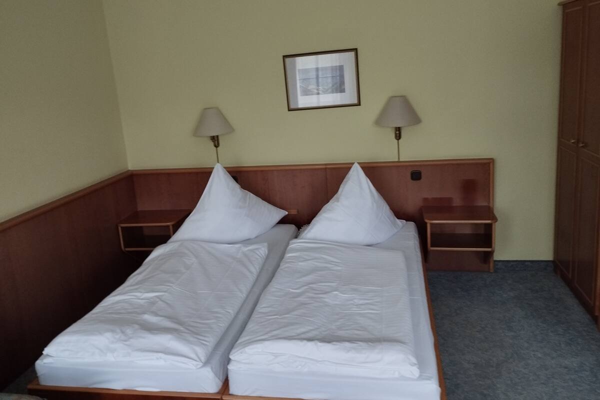 Double Room | Desk, blackout drapes, iron/ironing board (on request), travel crib