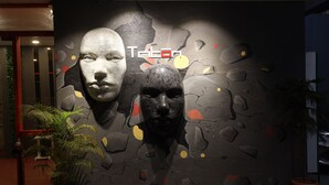 Un mur orné d’une fresque à motifs et sur lequel figure le mot « Trilan » au centre.