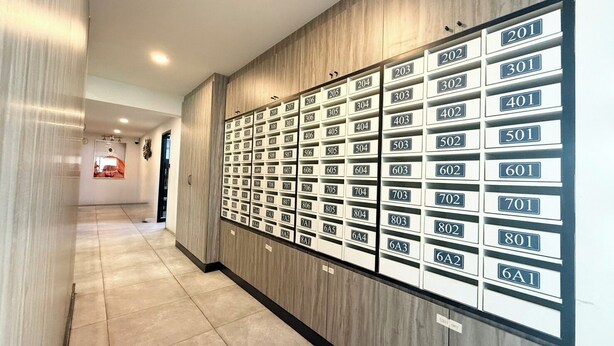 A hallway with a row of numbered hotel rooms on the right, a sign indicating 'STAFF ONLY' on the bottom right, and a corridor leading to a door at the end. - ABC@48 Hotel & Service Apartment (Bangkok)