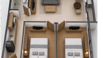 A two-bedroom apartment with a living area, kitchenette, and a balcony.
