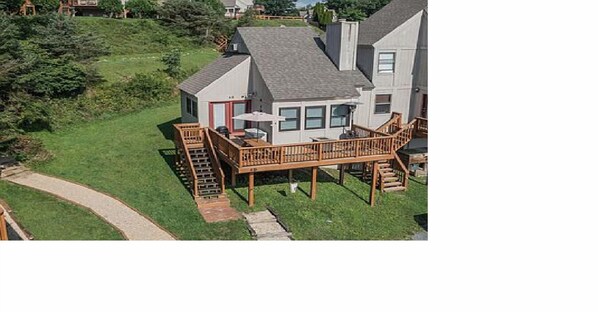 A two-story house with a deck and a staircase leading to the upper floor. - In the Heart of Deep Creek, Wood Fire, steps Lake, Coffee, Pizza, minutes Whisp, (Oakland)
