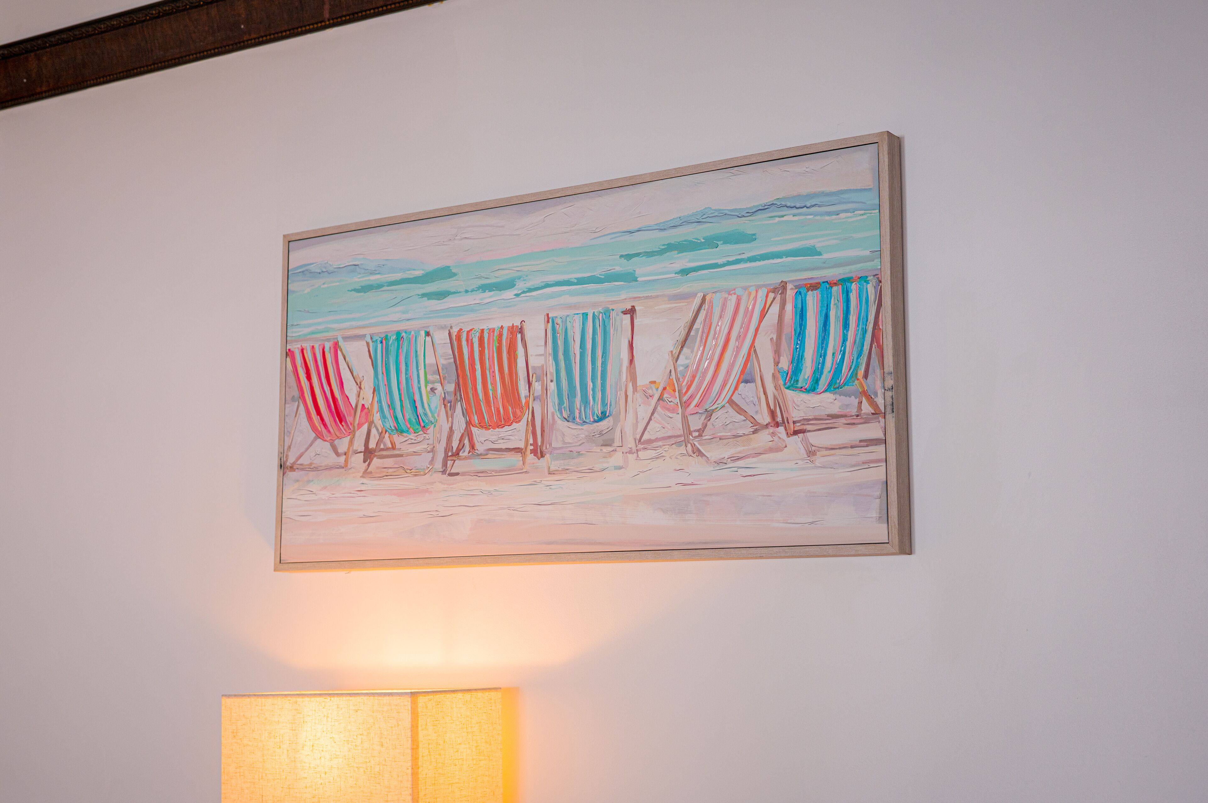 A painting of beach chairs on a wall.