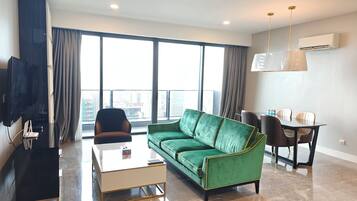 Premium Apartment | Living area | 50-inch Smart TV with satellite channels