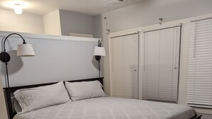 Ein Schlafzimmer mit einem Bett, einem Deckenventilator und einem Kleiderschrank.