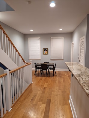 Enjoy meals in the dining area with a wooden table and chairs.