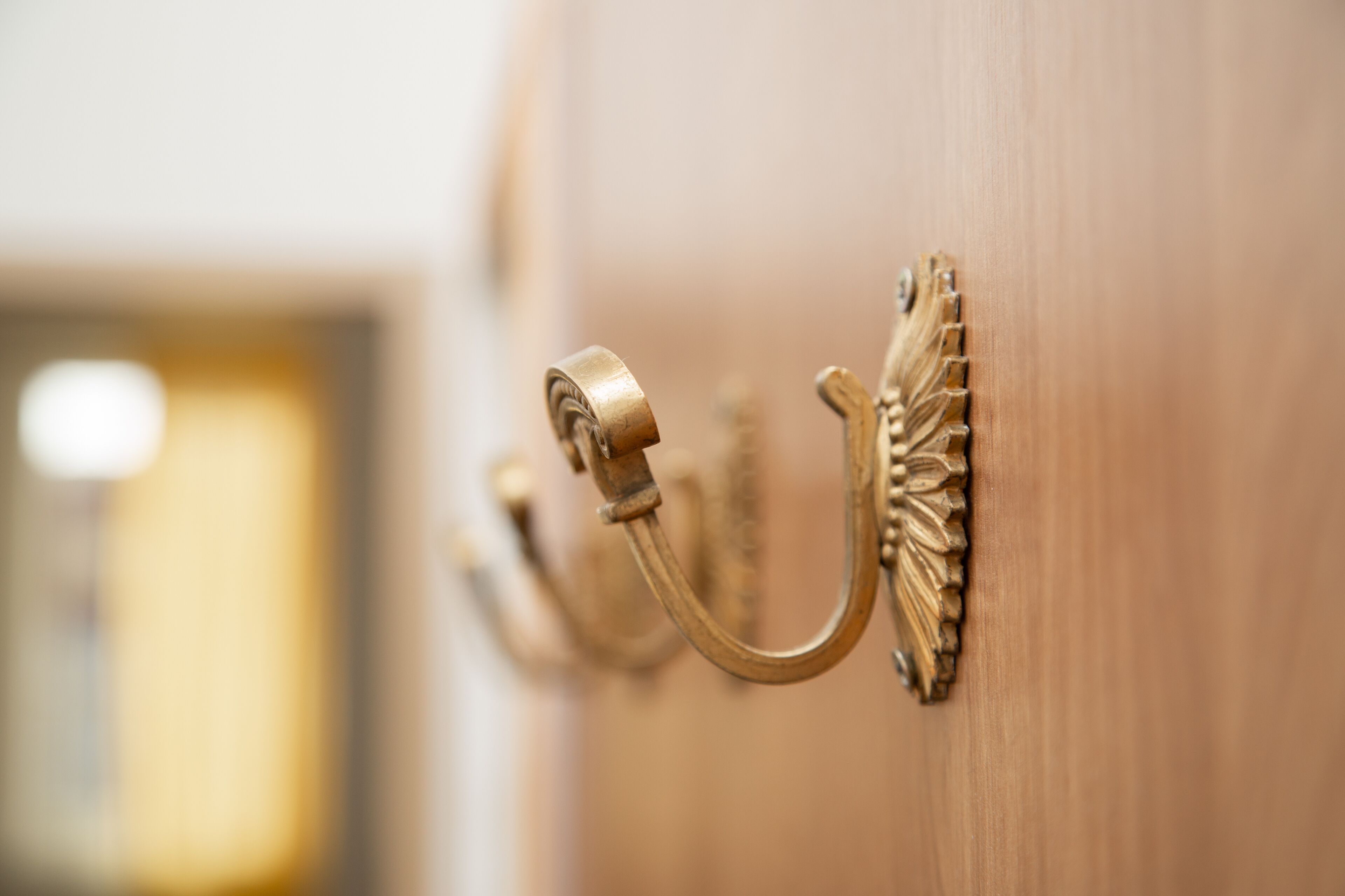 A brass door handle with a sunburst design.