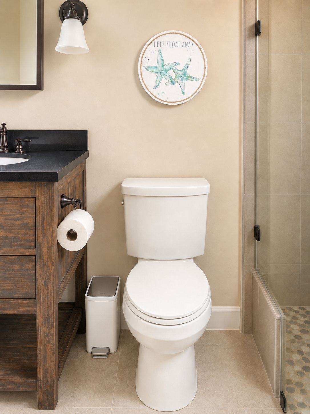 A bathroom with a toilet, a sink, a mirror, and a shower.