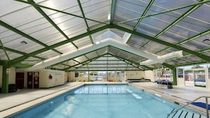 An indoor swimming pool with a glass ceiling and green metal beams. - Luxury Air Conditioned holiday Lodge . sleeps 5  Burgh Castle  Great Yarmouth (Burgh Castle)