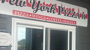 A New York Pizza II sign with a window displaying a food grade rating. - Beachfront 2-bedroom condo just steps away from sand, surf and sun. (Myrtle Beach)