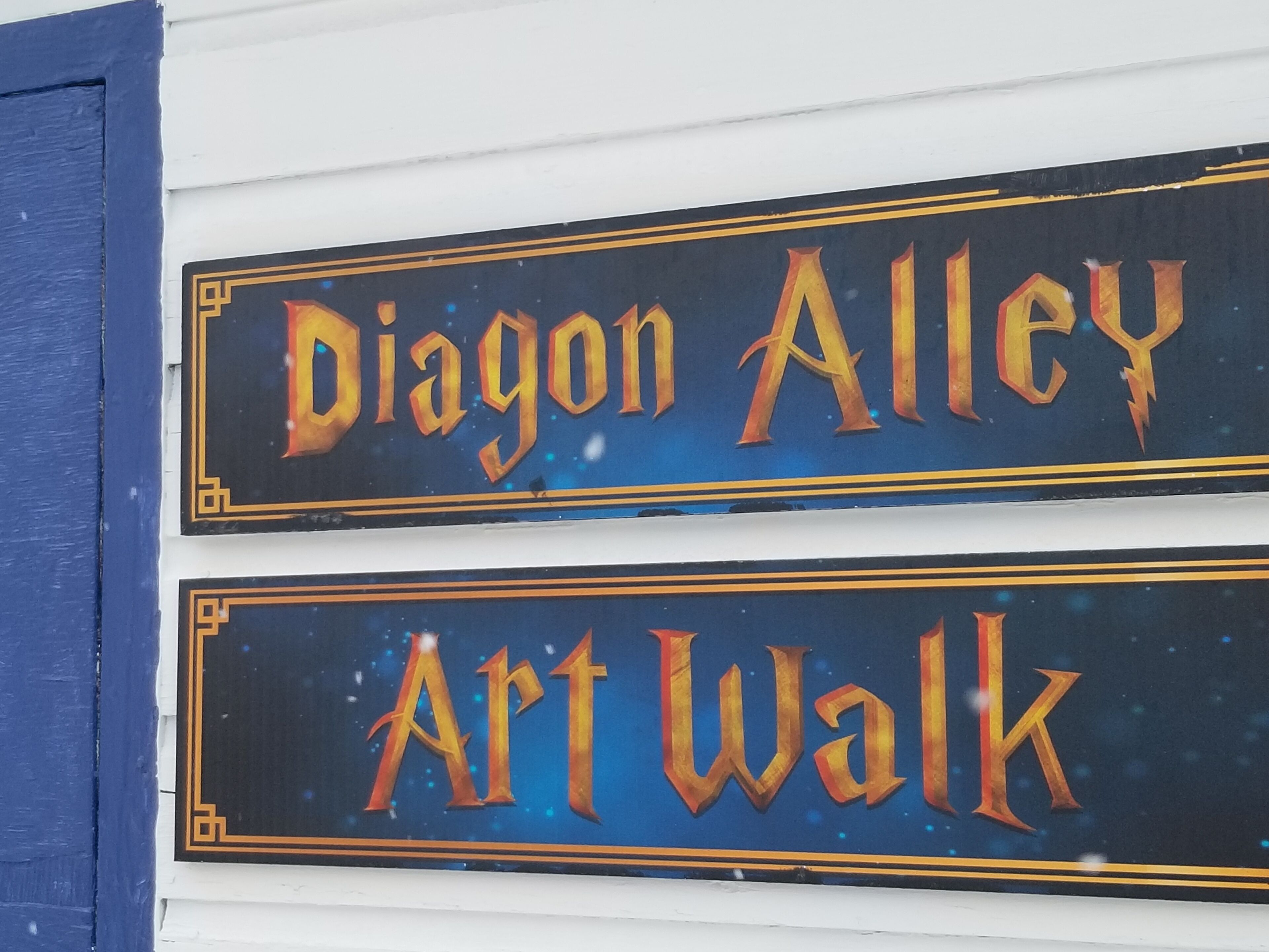 A sign with "Dragon Alley" and "Art Walk" written on it.