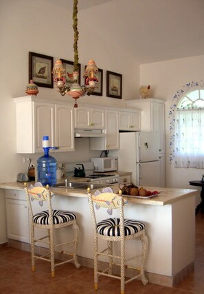 Fridge, cookware/dishes/utensils, dining tables