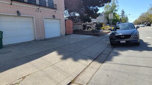 A residential house with a garage, a driveway, and a parked car.
