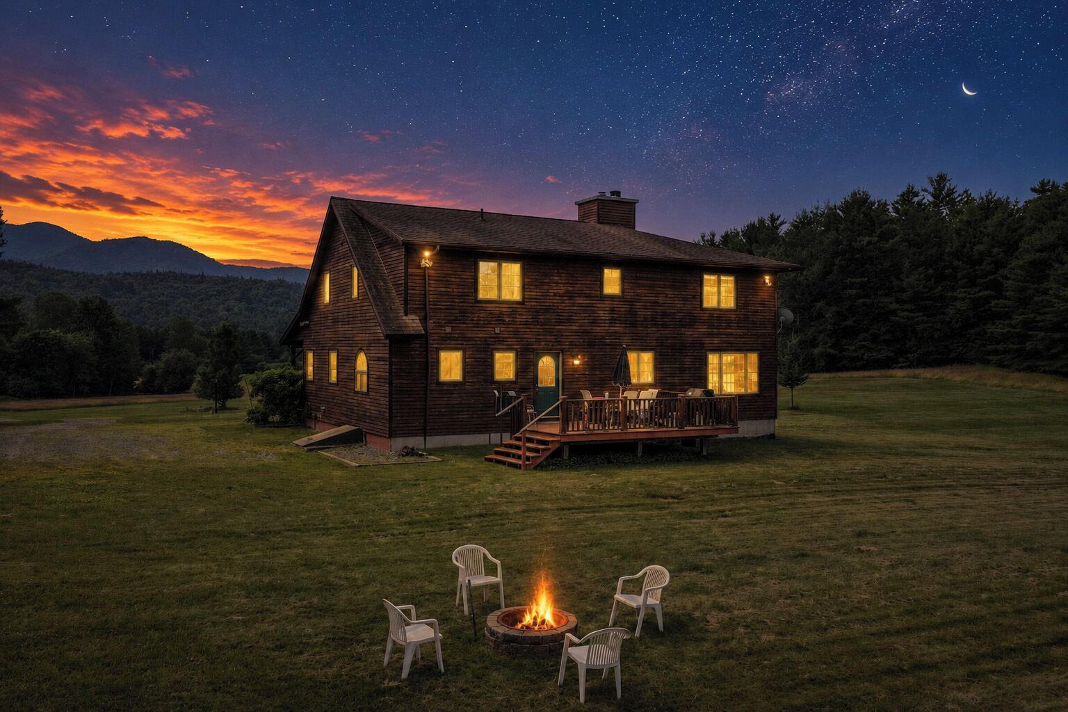 A wooden house with a deck and outdoor seating, surrounded by a grassy area and a starry night sky.