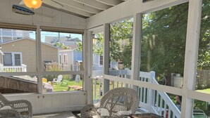 A covered porch with wicker furniture, a ceiling fan, and a view of the backyard. - Classic Old Orchard Beach Cottage One Block from the Beach (Old Orchard Beach)