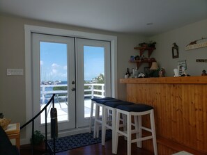 Enjoy the marina view from the comfort of your room, featuring a bar counter, decorative shelf, and a cozy seating area.