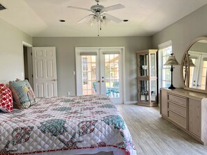 Master Bedroom facing french doors to pool. Quilts change periodically.