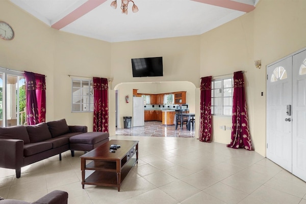 Living room with view of kitchen in background