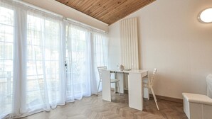 A room with a wooden ceiling, a white table with chairs, and sheer curtains on the windows. - Lovely home in Mouans-Sartoux with swimming pool (Mouans-Sartoux)