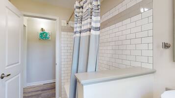 Combined shower/bathtub, towels, soap, toilet paper