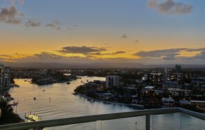 Panoramic views of the city skyline and river, with boats on the water and a bridge connecting the city.