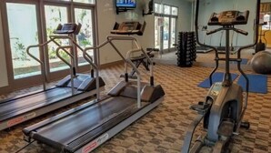 A gym with treadmills, an elliptical, and exercise balls.