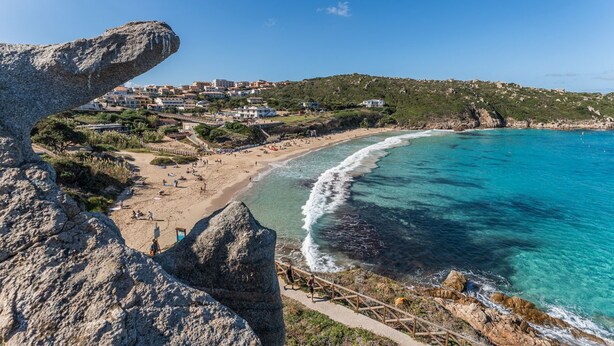 A coastal town with a beach, rocky cliffs, and buildings in the background. - (20/30 sq m): living room with kitchenette, double bed, single folding bed, bathroom. <br>Features: <br>tv, <br>ironing board and iron (on request) <br>kitchenette with induction hub, <br>oven, <br>kettle, <br>microwave <br>safe, <br>1 beach umbrella, <b (Santa Teresa di Gallura)
