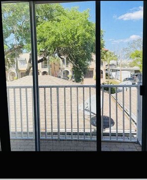 Enjoy the view from this balcony overlooking the bustling street scene below.