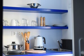 Fridge, stovetop, electric kettle, cookware/dishes/utensils