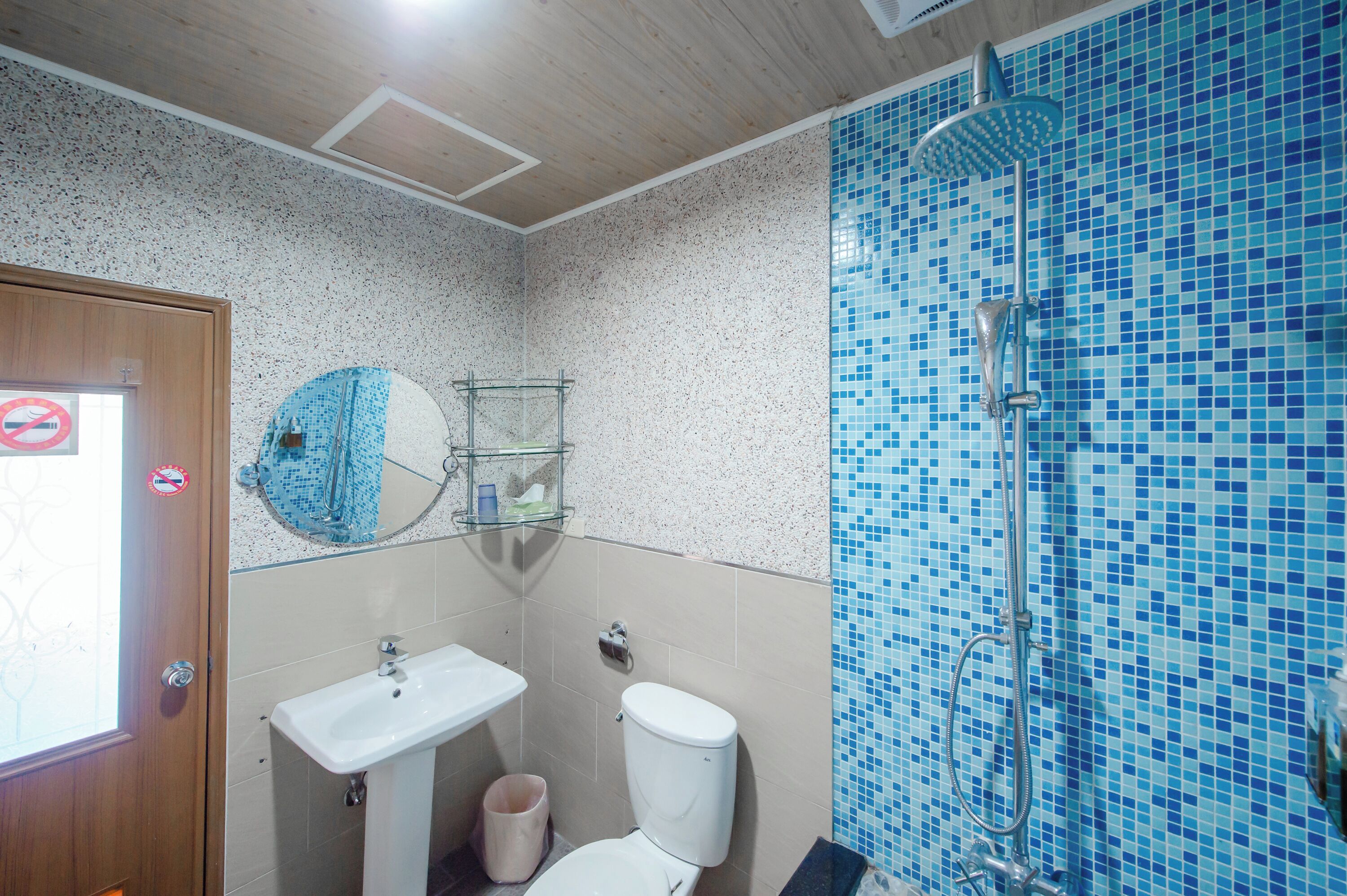 A bathroom with a sink, toilet, and shower.