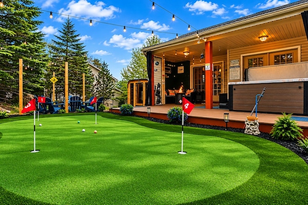 Grab a putter, line up your shot, and enjoy your own private putting green. When you're done, unwind in the hot tub or cozy up by the covered outdoor lounge.