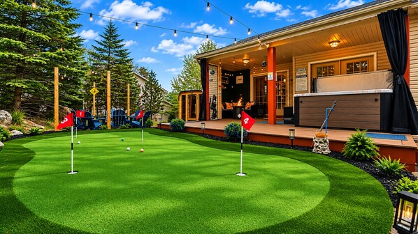 A well-maintained golf course with a wooden deck, outdoor seating, and a hot tub.
