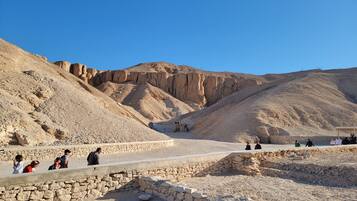 A desert landscape with ancient rock formations and a stone pathway.