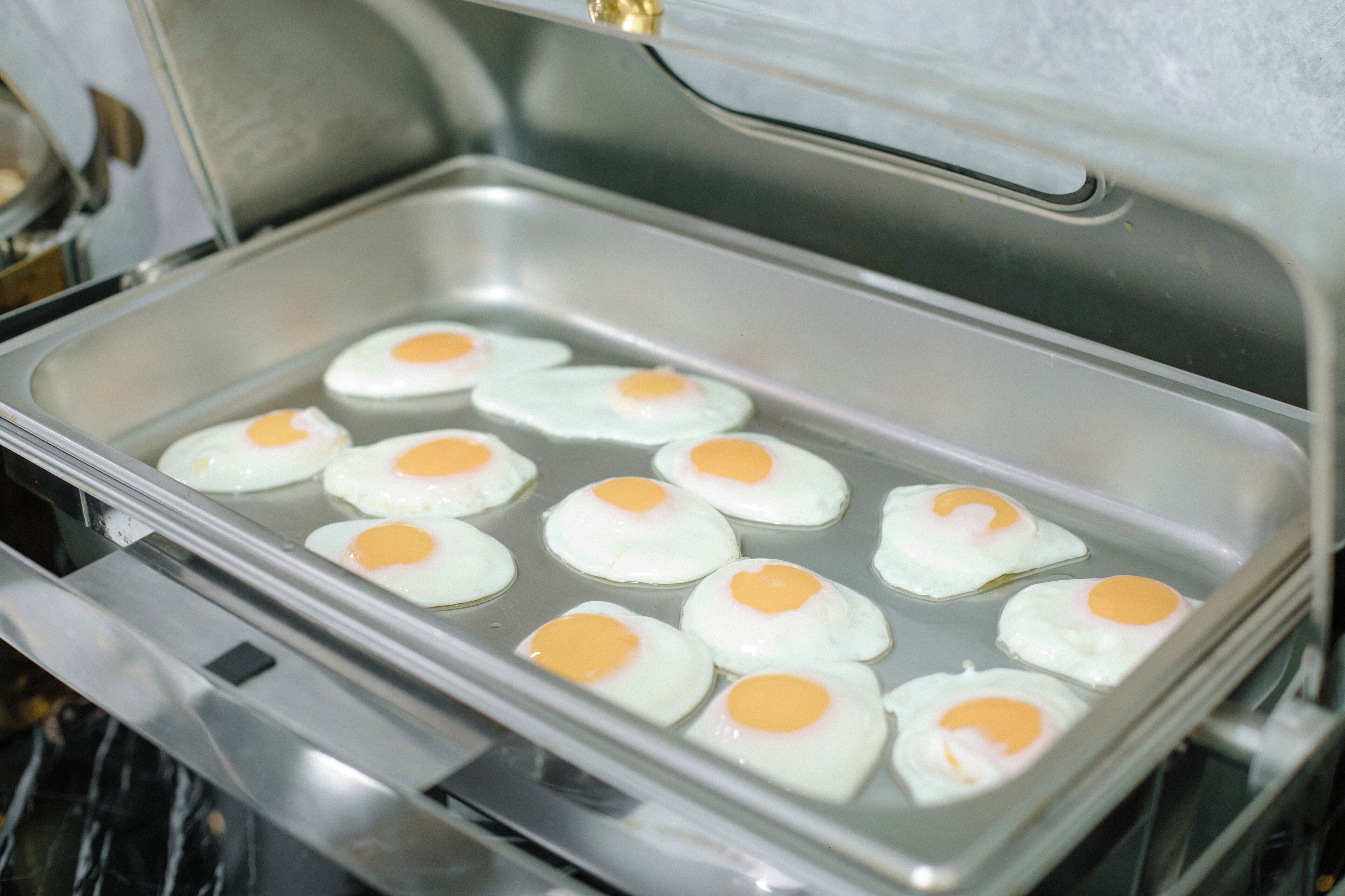 A tray with several fried eggs.