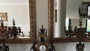 A grand room with a large ornate mirror, a central clock with cherubs, and classical furniture. - Palazzo Excelsus  (Terzigno)