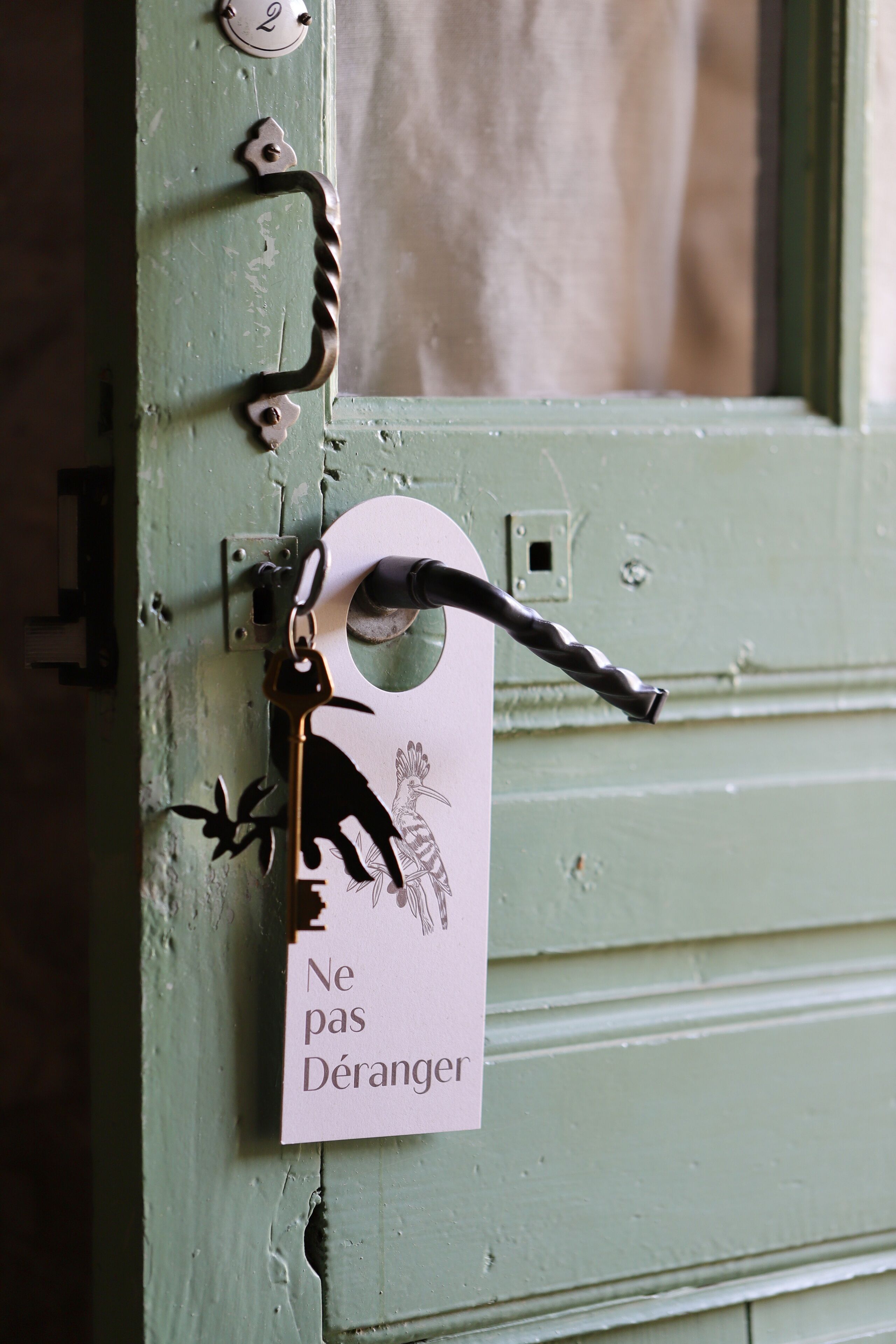 A green door with a keyhole and a key.