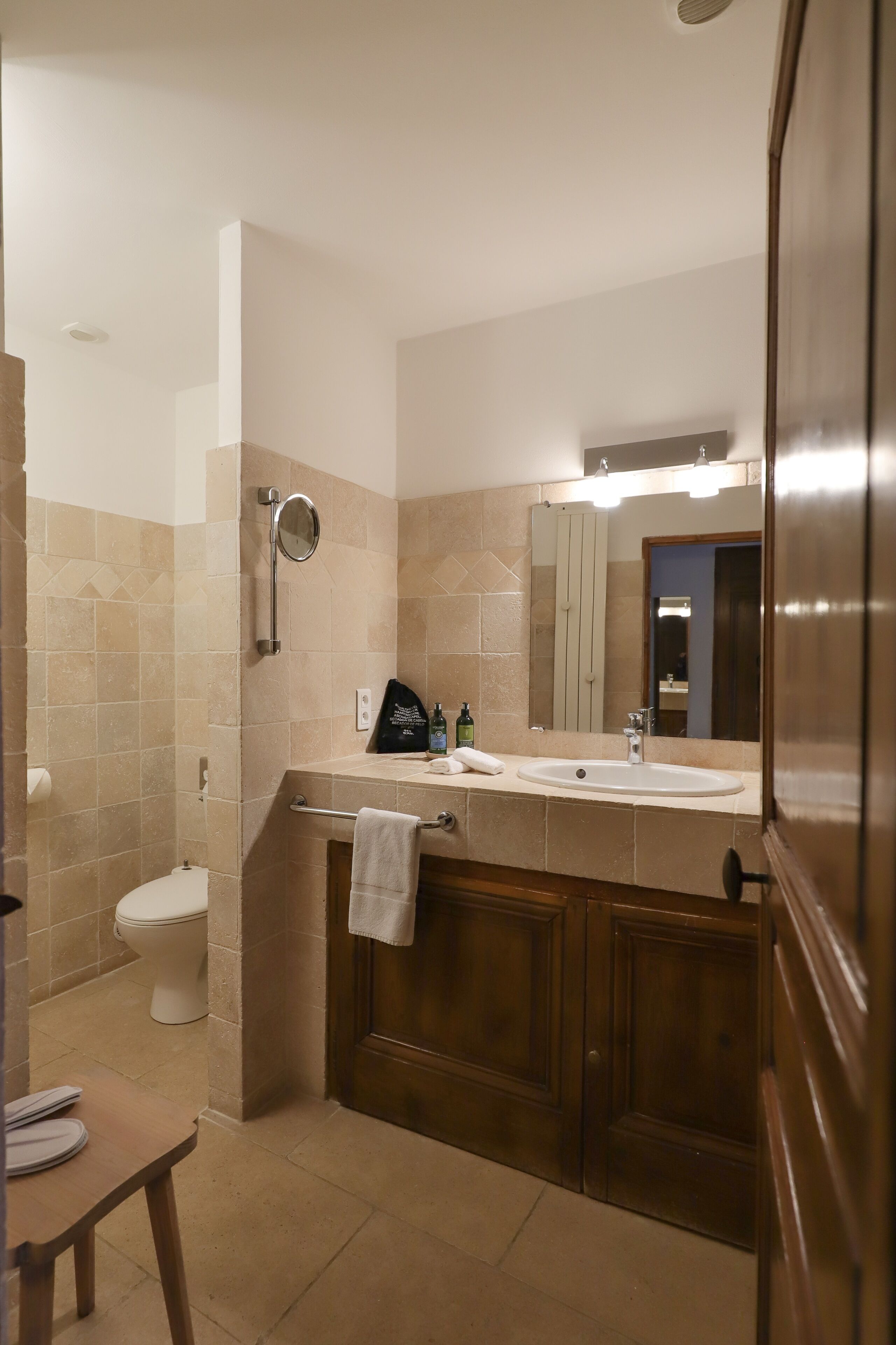 A bathroom with a toilet, sink, and shower.