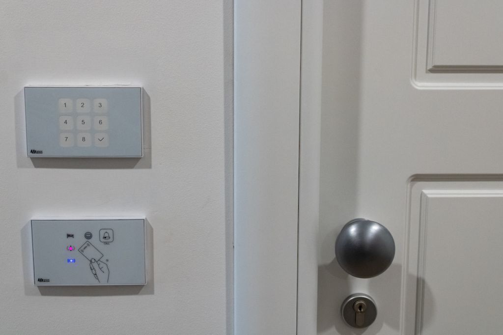 A door with a numeric keypad and a card reader for access control.