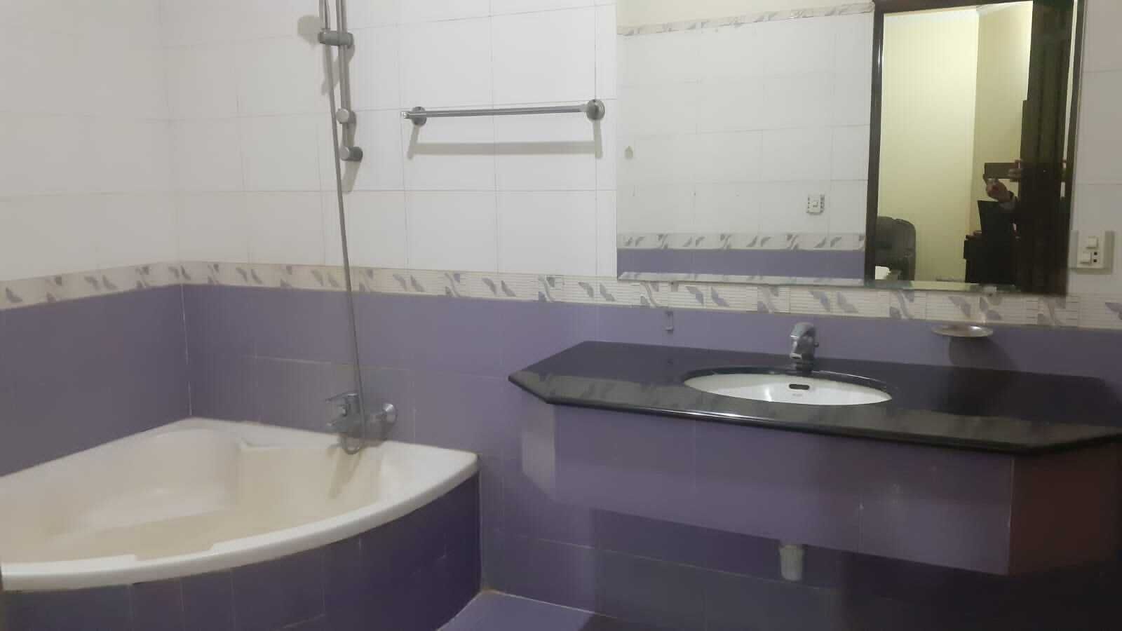 Une salle de bain avec une baignoire, un lavabo et un miroir.