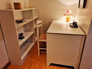 Work in comfort with a desk, chair, and shelving unit.