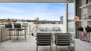 A modern outdoor seating area with a view of the cityscape.