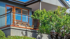 Enjoy a peaceful retreat with a balcony overlooking a serene garden.