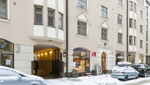 A building with multiple windows and a storefront with a sign. - 2ndhomes Central 85m2 2BR Apartment (Helsinki)