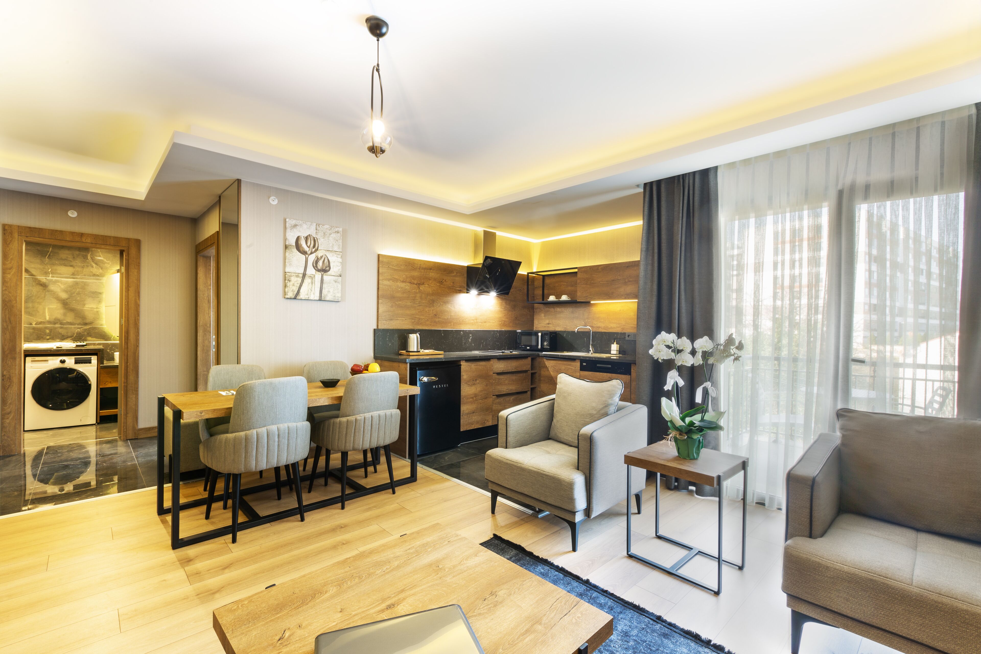 A modern living room with a dining area, a sofa, and a small table with a plant.